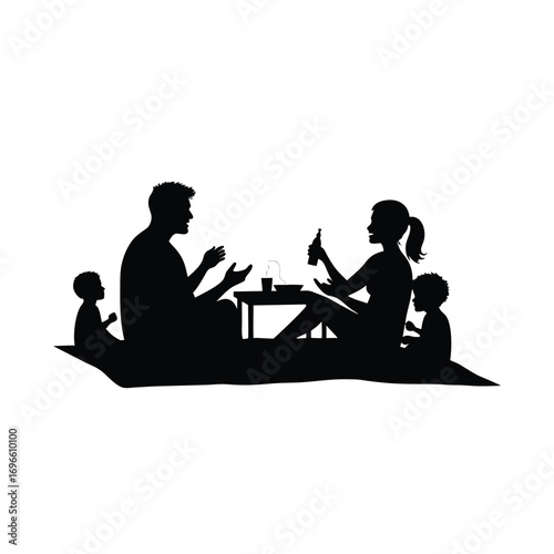 Family picnic silhouette with drinks and snacks on a blanket