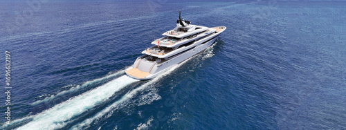 Aerial drone ultra wide tracking photo with copy space of beautiful modern super yacht with wooden deck cruising in high speed deep blue Aegean sea
