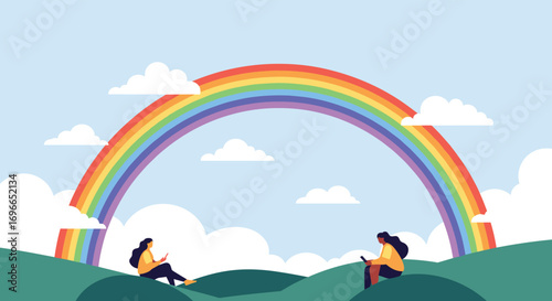 Two women sit on green hills gazing at a vibrant rainbow under a cloudy blue sky