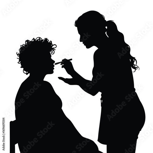 Makeup Artist Applying Makeup to Client Silhouette