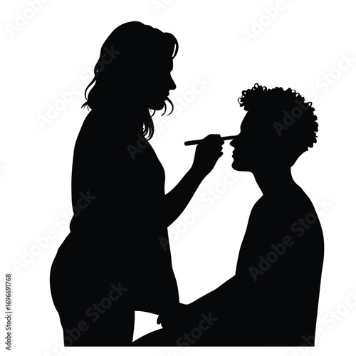 Makeup Artist Applying Makeup to Client Silhouette