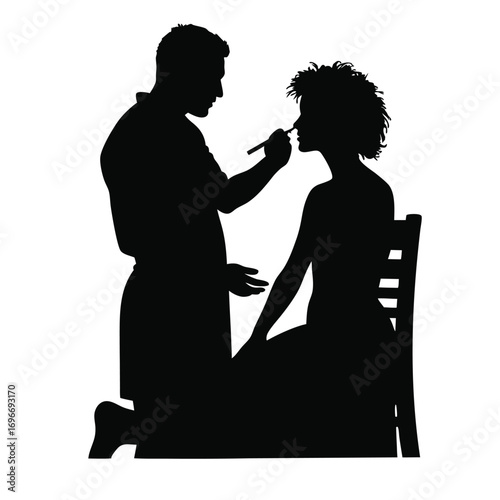 Man applying makeup to woman on chair silhouette application