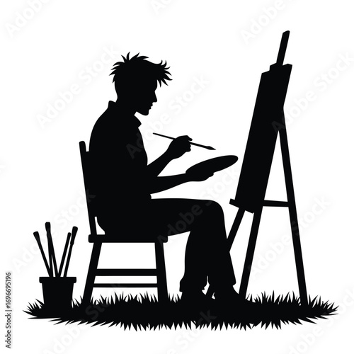 Man artist painting on easel with brush holder canvas