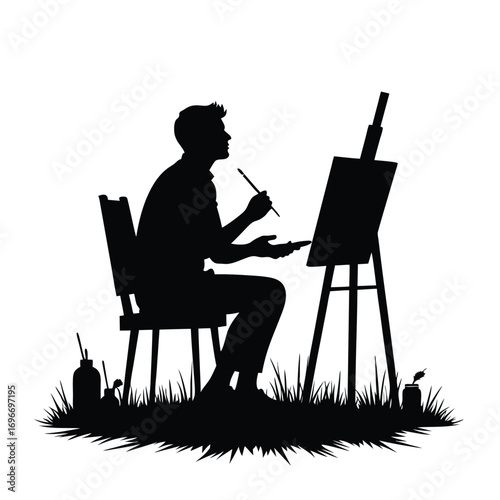 Silhouette of a man artist painting outdoors on a white background