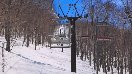 POV shot from a ski lift moving through a forest (Tsugaike Mountain Resort, Hakuba, Nagano, Japan)