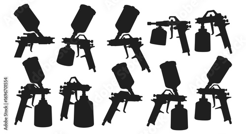 various spray paint guns arranged neatly silhouette