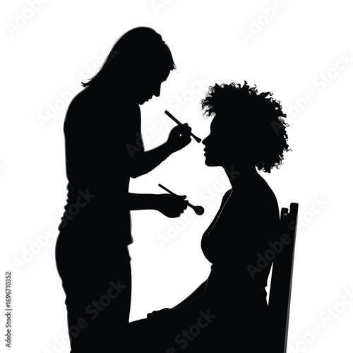 Silhouette of makeup artist applying makeup to woman on chair Keywords: silhouette, makeup