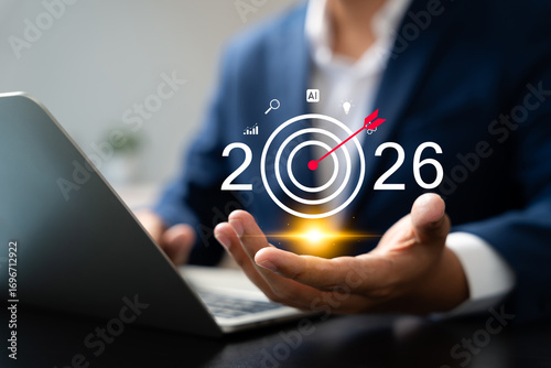 Businessman planning 2026 business goals with a digital target icon, showing strategic planning, growth, innovation, and future success in finance and AI-driven business development.