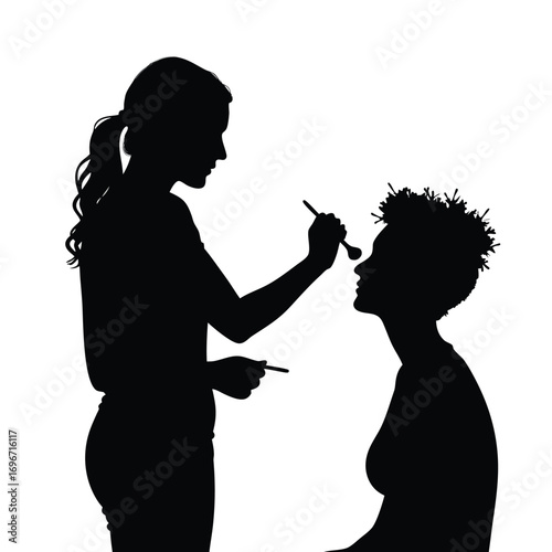 Silhouette of woman applying makeup to another woman