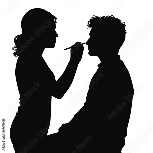 Woman applying makeup to man's nose silhouette application