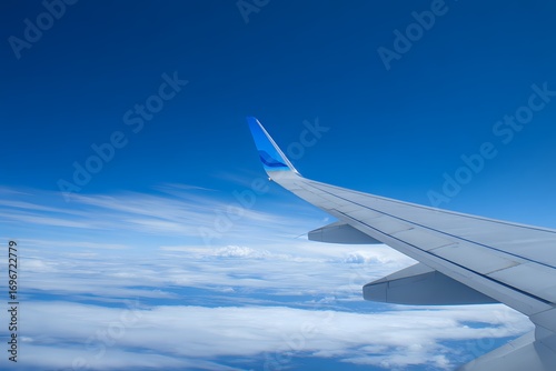 Wing Detail: Passenger Plane Against Blue Sky