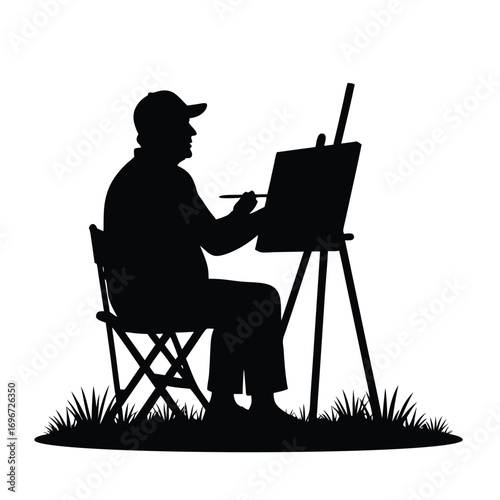 Artist silhouette painting on canvas in a seated position outdoors