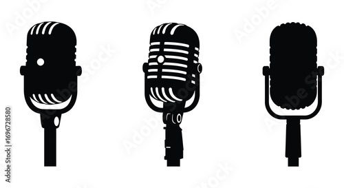 three vintage microphones stand side by side silhouette