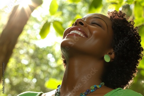 Woman enjoys sunlight in a lush green forest, embracing nature and vitality during a sunny day