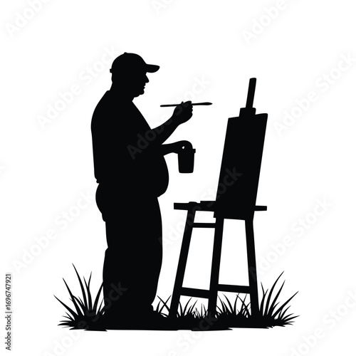 Silhouette of a standing artist painting with a brush and cup