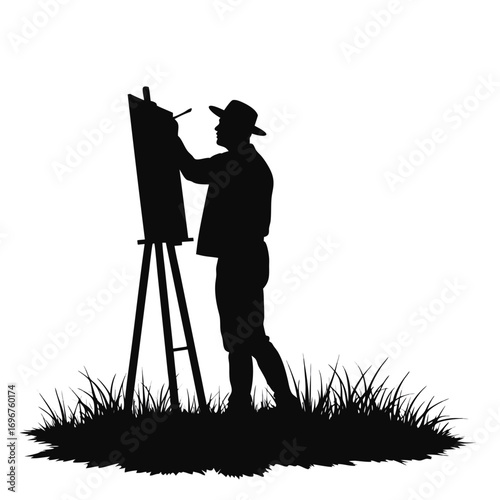 Silhouette of man painting on easel outdoors artist