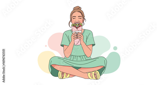 Delighted Woman Relishing a Wrap While Sitting Comfortably on the Ground Enjoying a Meal