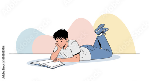 Young Man Reads and Relaxes, Enjoying A Book On The Floor With Simple Artistic Background