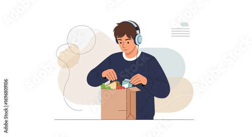 Young Man Unpacks Groceries While Listening to Music at Home Enjoying Fresh Food