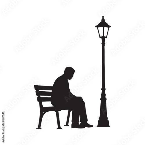 Silhouette of a Man Sitting Alone on a Bench Under Street Lamp