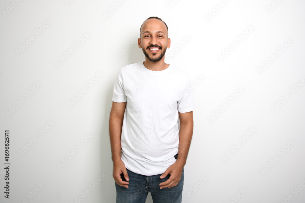 Fototapeta premium young islamic arab man against white studio wall