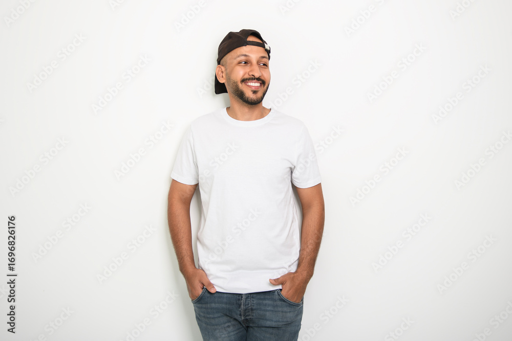 Fototapeta premium young islamic arab man against white studio wall