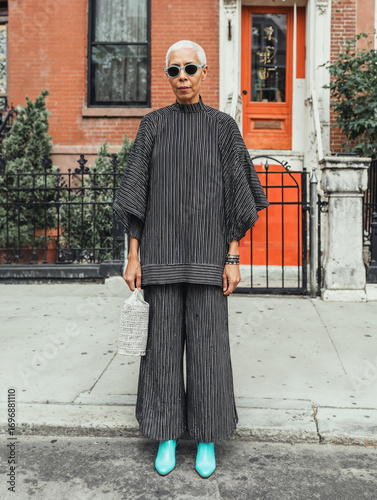 Portrait of senior stylish Black woman in front of her home in NYC