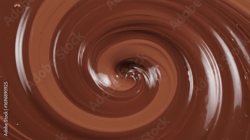 Swirling Melted Chocolate Texture - Close-up shot of rich, brown melted chocolate swirling in a circular pattern.
