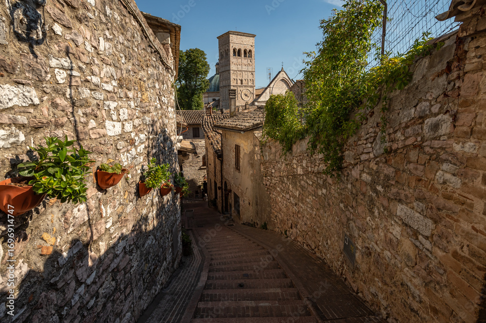 Naklejka premium Beautiful Tuscan historical street and place in the city of Assisi, Tuscany, Italy, Europe. Medieval atmosphere