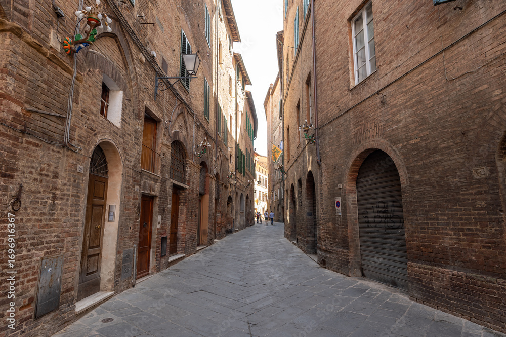 Naklejka premium Beautiful Tuscan historical street and place in the city of Siena, Tuscany, Italy, Europe. Medieval atmosphere