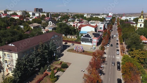 Panoramic aerial view of central Comrat with main street, church and surrounding urban landscape.