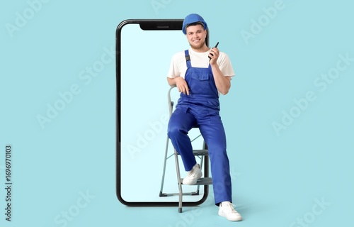 Male worker and big smartph...