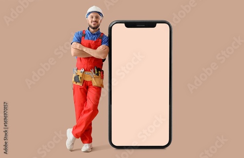 Male worker with big smartp...