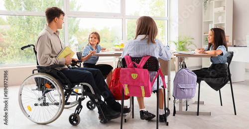 Male teacher in wheelchair ...