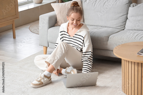 Young woman using modern la...