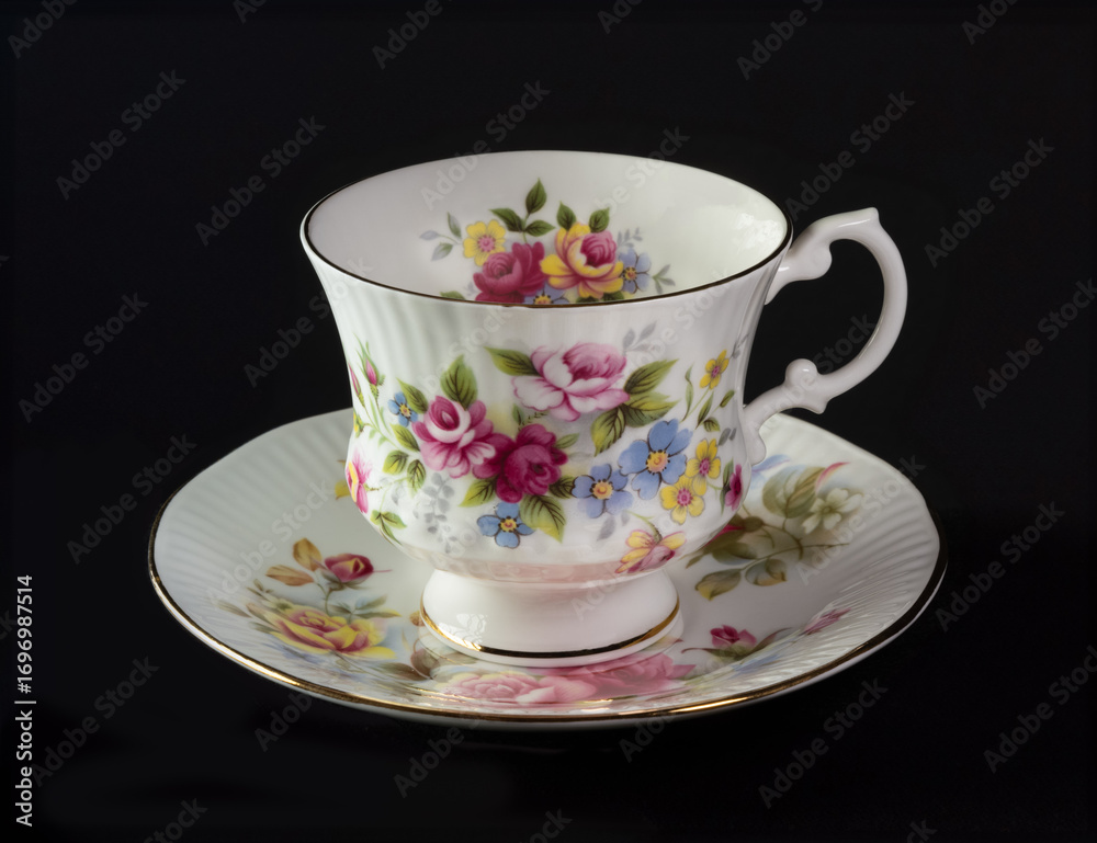 Fototapeta premium Beautiful teacup with flowers and white handle