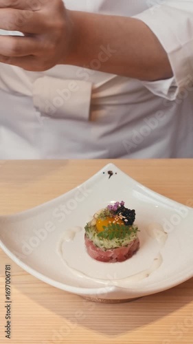 close up asian food preparation of traditional sushi rolls. presentation of dishes of Asian haute cuisine in Michelin-starred restaurant. chef hands create cuts decorates dish slow motion. Chef coat