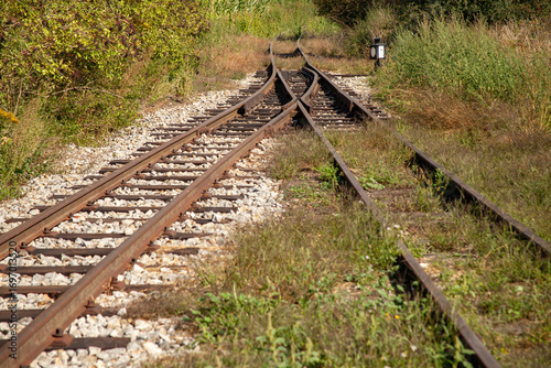 Fotografi Railway tracks splitting in different directions, symbol of choice, journey and