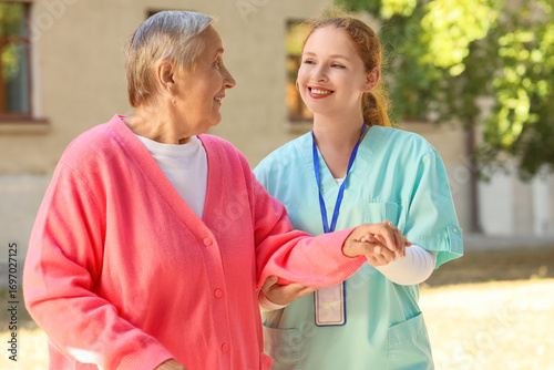 Nurse with senior woman hol...