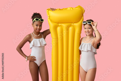 Cute little girls in swimsu...