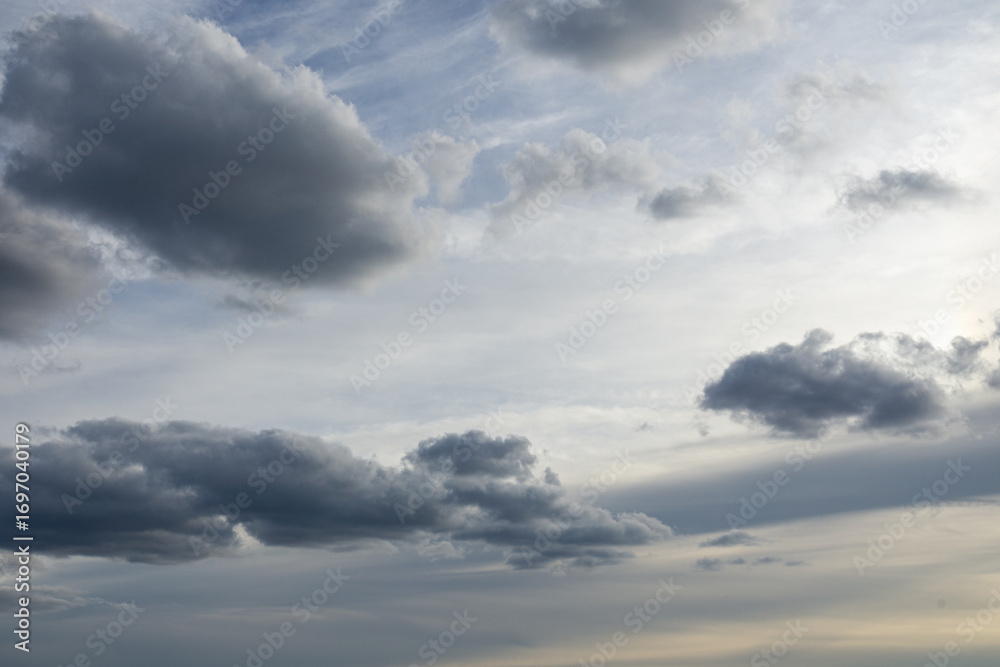 Fototapeta premium Dramatic sky with scattered clouds. Atmospheric view of layered clouds during the day.