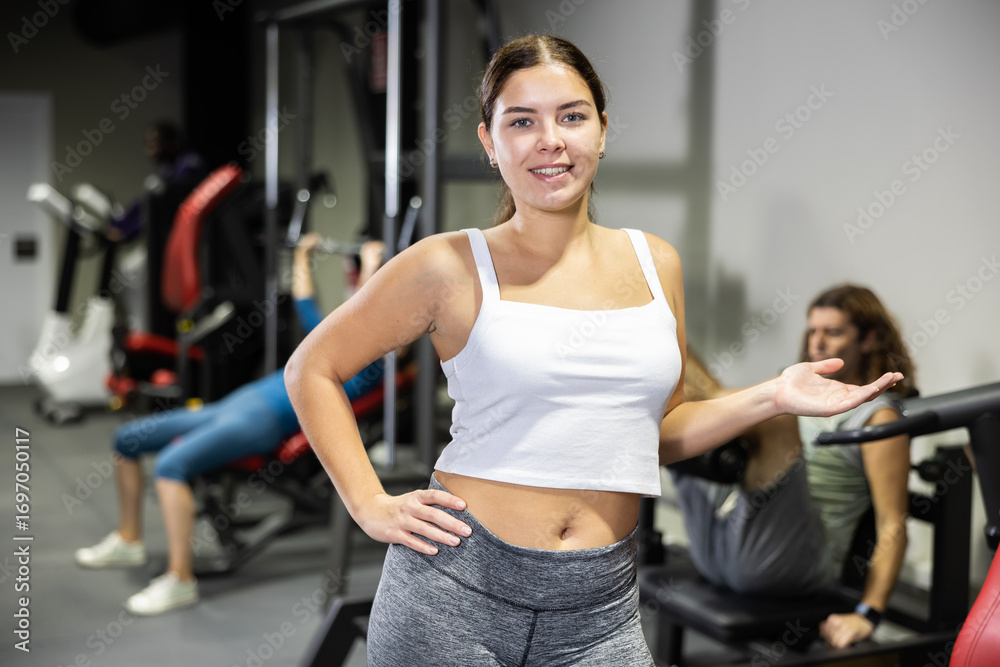 Obraz premium Portrait of slim woman smiling after a work out in gym
