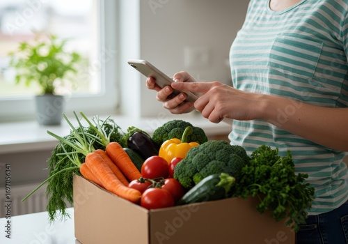 Woman ordering groceries online with fresh produce.