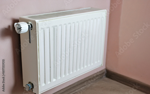 Wallpaper Mural White home radiator with control valve on pink wall for efficient heating Torontodigital.ca