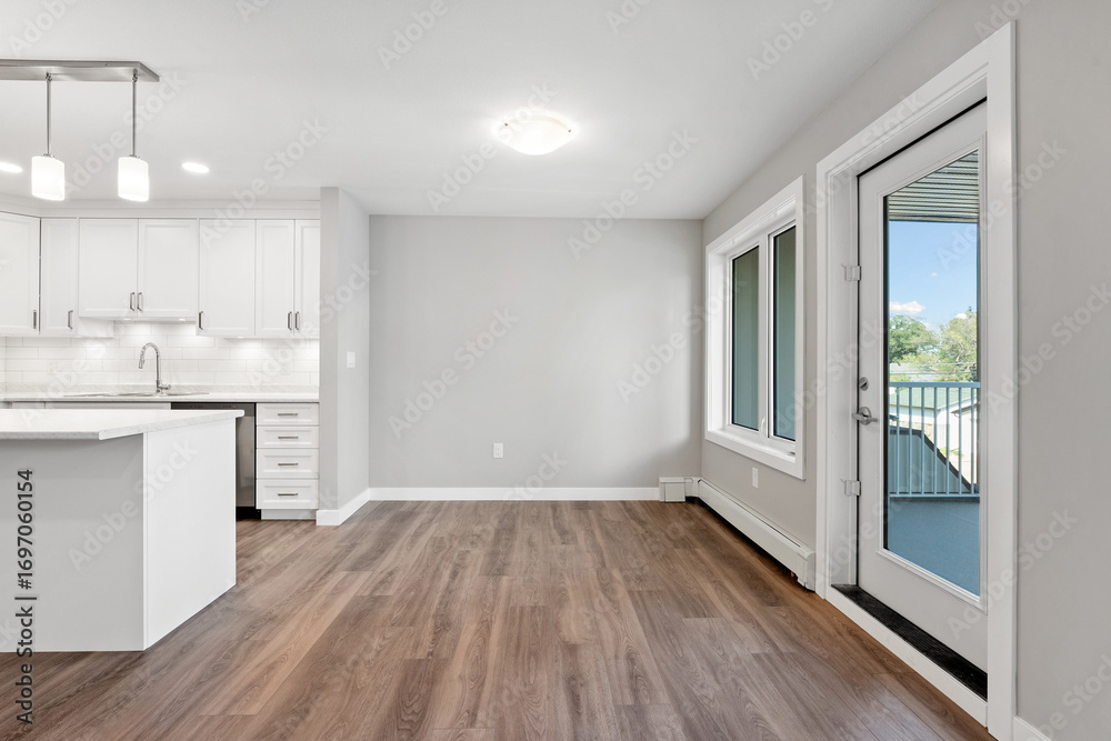 Fototapeta premium Large open kitchen with a white island and a large window