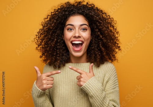 Excited woman pointing at something with a big smile