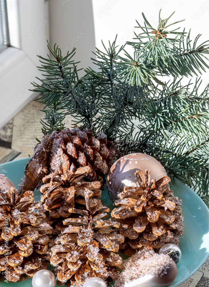 Obraz premium Christmas decoration with pine cone, branch. New Year ornament for winter holiday season decor. Traditional festive celebration.