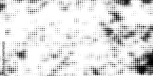Grunge halftone gradient background. Faded gritty noise texture. Monochrome texture for printing on badges, posters, and business cards. Vintage pattern of randomly arranged dots.