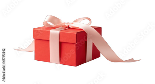Wrapped red gift box with a large peach-colored ribbon, against black