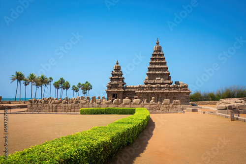 Shore temple in mahabalipuram with palm trees and blue sky